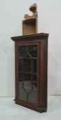 Oak wall-hanging corner display unit with astragal glazed door enclosing shelves and a pine wall-