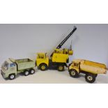 Three Tonka Matchbox large trucks and crane, together with leather case with further Tonka toys