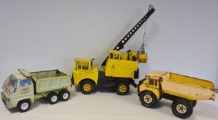 Three Tonka Matchbox large trucks and crane, together with leather case with further Tonka toys