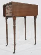 19th century drop-leaf table, the rectangular top with rounded corners, above two drawers, on turned