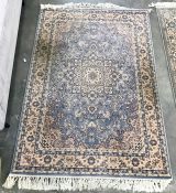 A Persian style wool rug,  light blue ground, allover floral decoration in pink, cream and dark