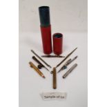 Assorted brass drawing instruments in cylindrical red leather case, a propelling pencil in silver