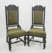 In the manner of Godwin pair of ebonised chairs, the carved top rail with four interlinking carved
