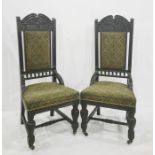 In the manner of Godwin pair of ebonised chairs, the carved top rail with four interlinking carved