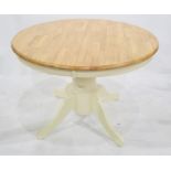 Modern dining table of circular form, cream painted base