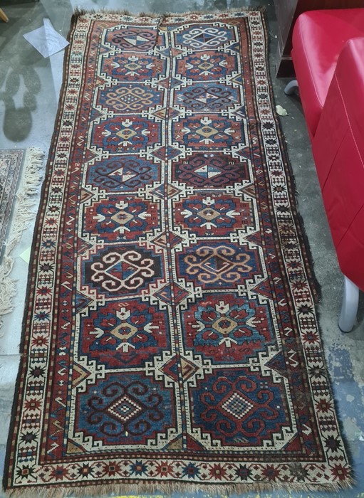 Eastern runner with two rows of nine medallions, in blues, reds and whites, 278cm x 123cm