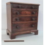 19th century mahogany miniature chest of drawers, the rectangular top with applied moulded edge,