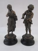 Pair of bronze effect figures, children reading books, on socle bases