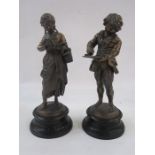 Pair of bronze effect figures, children reading books, on socle bases