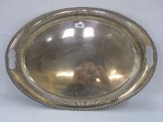 Early 20th century silver two-handled oval tray with gadrooned border, with reeded rim,