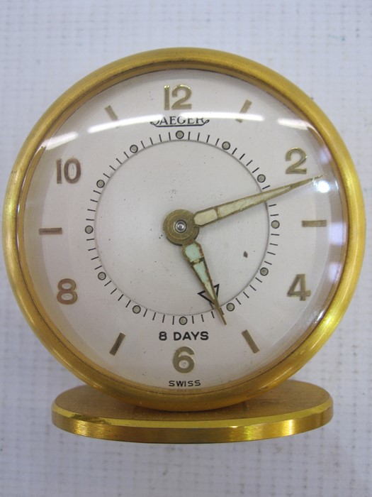 Jaeger 8-day travelling alarm clock, the circular dial with numerals and baton markers, hand