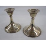 A pair of 1950s squat silver-mounted candlesticks, plain tapered form on circular bases,