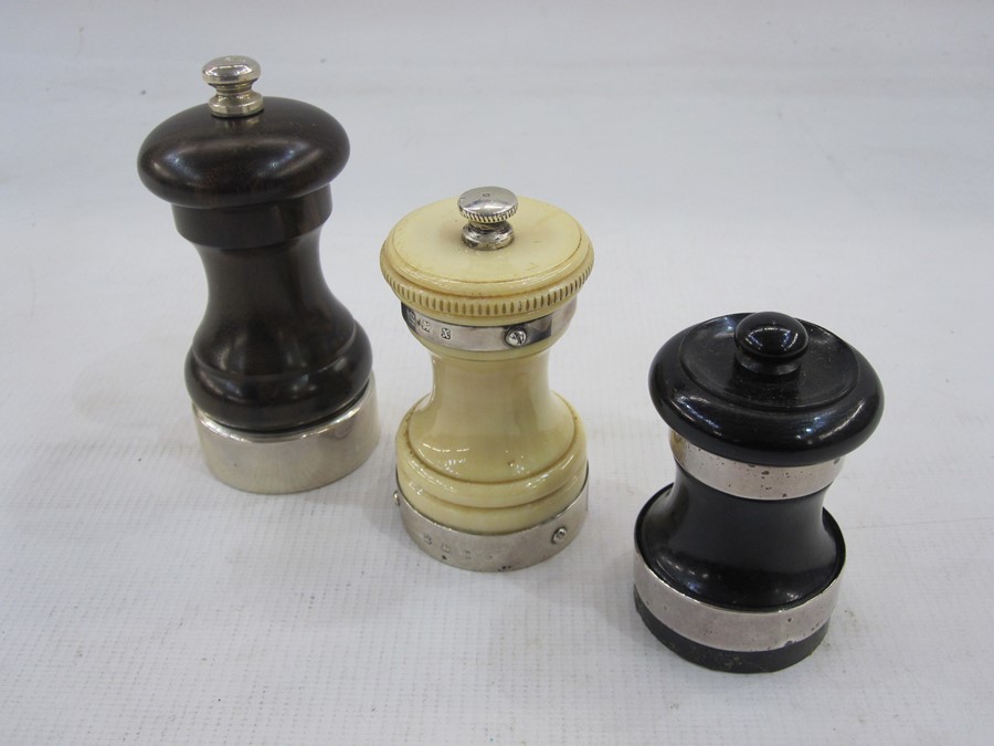 Modern turned wooden pepper grinders with silver mounts, London 2008, another turned wood example