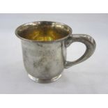 American sterling silver mug of plain form on collet foot with gilt interior, the base inscribed