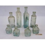 Collection of eight chemist and ink glass bottles including one from Osmond & Son Ltd, Grimsby