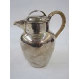 An early 20th century silver milk jug, with lid and cane covered handle, Birmingham 1901, maker's