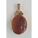 Large 9ct gold double-sided pendant set with red and brown variegated agates, with scroll pendant