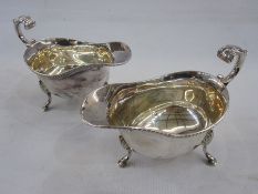 Pair silver sauceboats of revived Georgian style, gadrooned borders and open C-scroll handles,