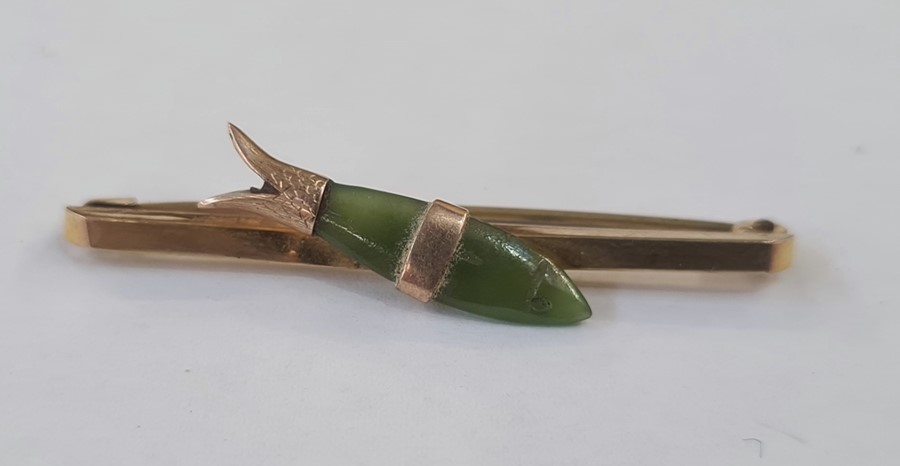 Gold coloured bar brooch set with a jade fish