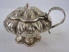 A George IV silver lidded mustard pot, floral repousse decoration, on sexafoil base, London 1828,