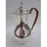 Edwardian silver hot water jug by John Henry Rawlings, London 1905, with gadrooned border and cane