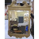 George II style gilt wall mirror with swan-neck pediment in gilt carved wood with foliate, scroll