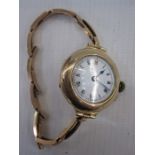 Early 20th century 9ct gold bracelet watch, the circular enamel dial in hunter style gold case and