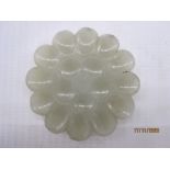 Chinese carved jade plaque, pale celadon, in the form of a flowerhead with concave petals and