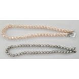 Two cultured pearl necklaces, one pink, each pink pearl 1cm diameter approx, 46cm long approx and