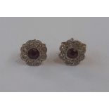 Pair ruby and diamond flower cluster stud earrings set central ruby (worn) and small diamonds