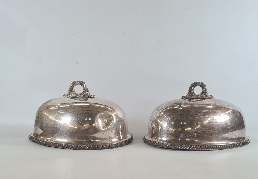 Pair silver plated dome meat covers with foliate handles, gadrooned borders
