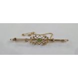 Gold-coloured metal, peridot and seedpearl bar brooch, the central peridot within sprays of small