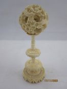 Early 20th century Chinese carved ivory puzzle ball on stand with three graduated leaf-pattern