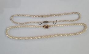 Graduated row of cultured pearls with 9ct gold clasp set with an oval mix-cut amethyst surrounded by