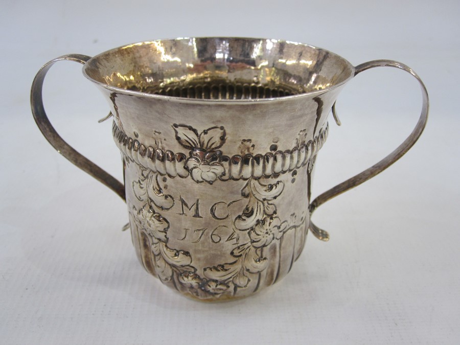 LOT WITHDRAWN ****************  A George III silver two-handled christening mug, repousse and