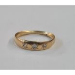 Gold and diamond ring, the gold band set three old cut diamonds in rubover setting (worn)