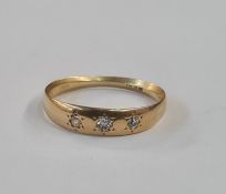 Gold and diamond ring, the gold band set three old cut diamonds in rubover setting (worn)