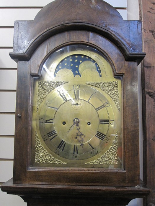 19th century longcase clock, the arched top with moonphase and striking eight-day movement, brass