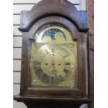 19th century longcase clock, the arched top with moonphase and striking eight-day movement, brass