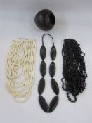 A carved ebony necklace, a black stained wood necklace, multi layered, a resin /wood multi layered