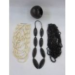 A carved ebony necklace, a black stained wood necklace, multi layered, a resin /wood multi layered