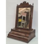 19th century mahogany swing toilet mirror, the rectangular plate surmounted by carved and shaped