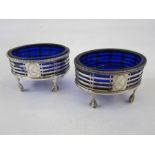 A pair of Victorian silver salts with blue glass liners, oval shaped, pierced decoration, with