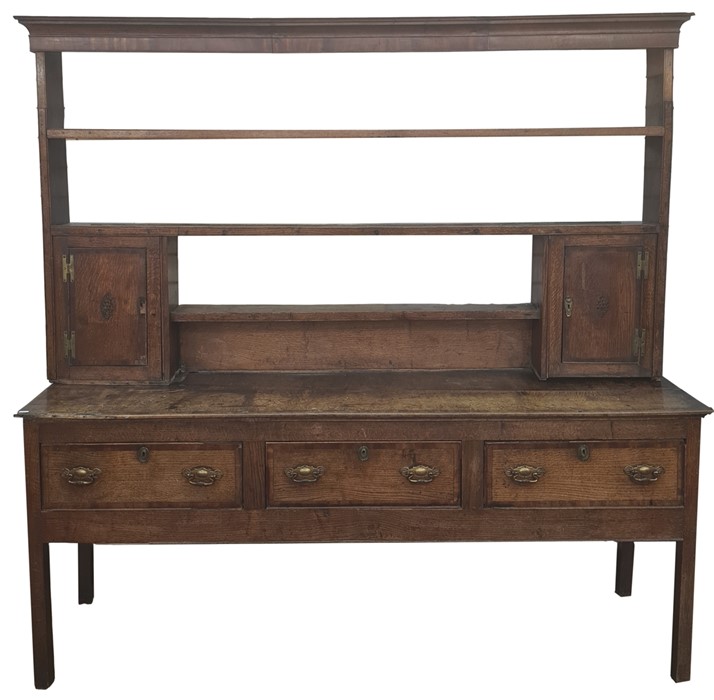 19th century North Country oak and mahogany banded dresser, the cavetto moulded cornice above open