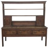 19th century North Country oak and mahogany banded dresser, the cavetto moulded cornice above open