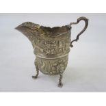 A Victorian silver cream jug, repousse decoration of dog, fox, duck, fish and partridge amongst