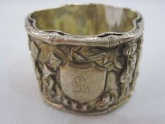 Oriental silver napkin ring with relief decoration of figures in landscape riding animals,
