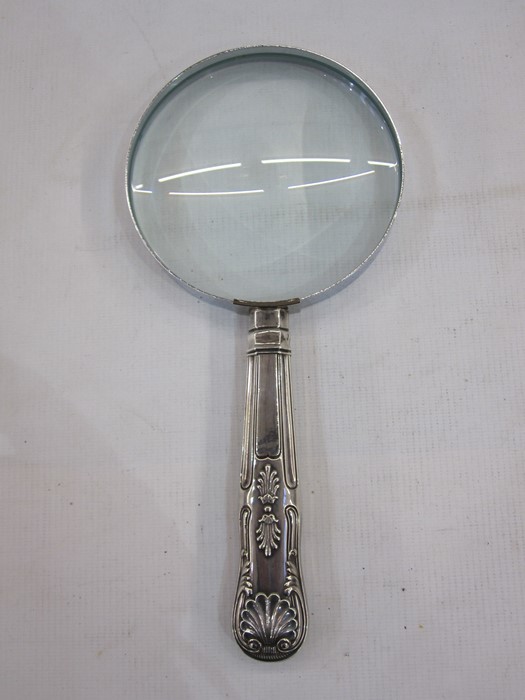 A 1920s silver handled magnifying glass, repoussé decoration to handle, Sheffield 1924, makers