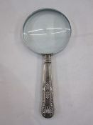 A 1920s silver handled magnifying glass, repoussé decoration to handle, Sheffield 1924, makers