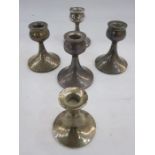 A set of four mid 20th century squat candlesticks, cup shaped holder on a tapered circular base,